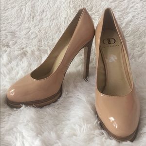 Kelsi Dagger nude patent heeled pumps.